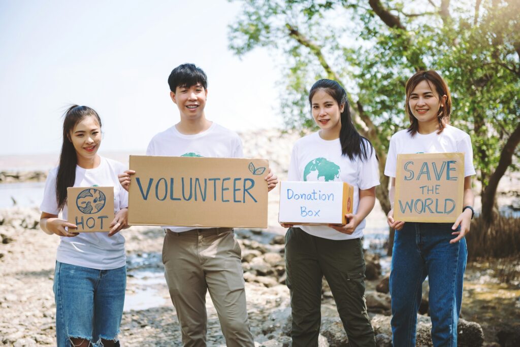 Group of volunteers hold a volunteer sign in world environment day event, volunteer conservation.