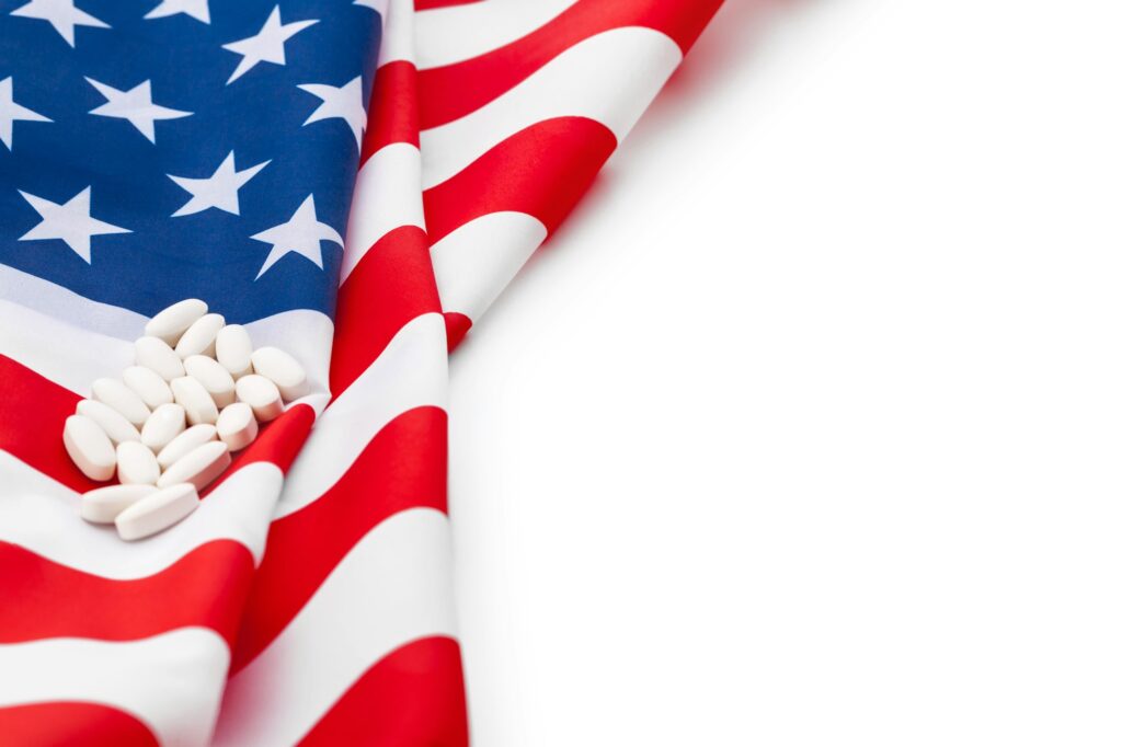 White prescription pills on United States flag